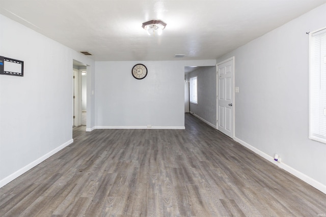 unfurnished room featuring dark wood-type flooring