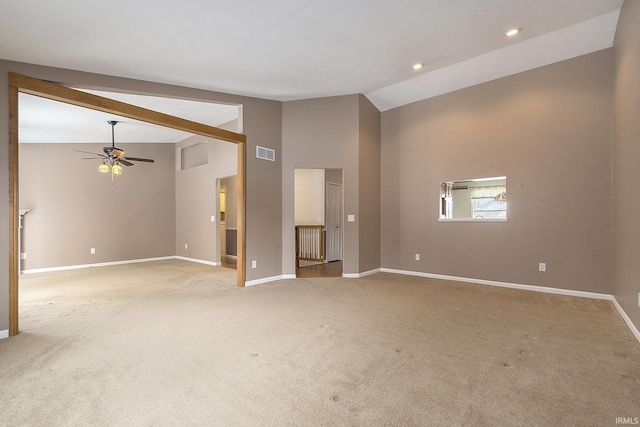 unfurnished living room with high vaulted ceiling, light colored carpet, ceiling fan, and beamed ceiling