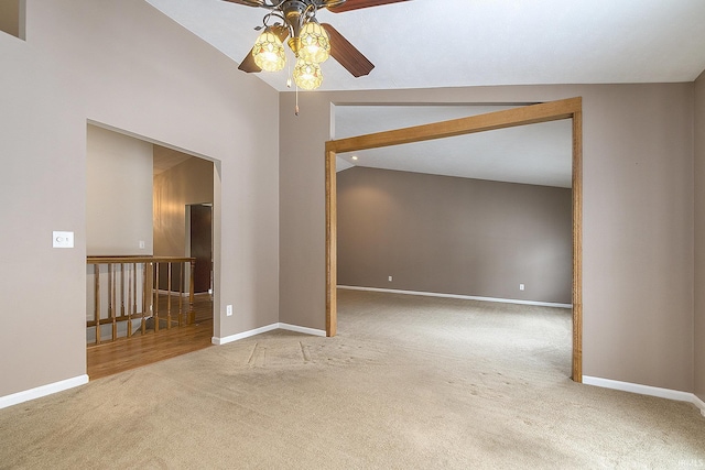 unfurnished room with lofted ceiling, ceiling fan, and carpet flooring