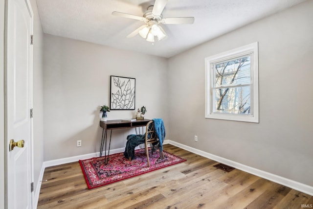 office area with ceiling fan and hardwood / wood-style flooring