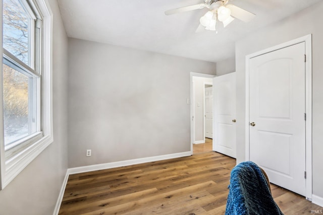 bedroom with ceiling fan and wood-type flooring