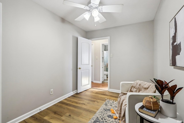 living area with light hardwood / wood-style floors and ceiling fan