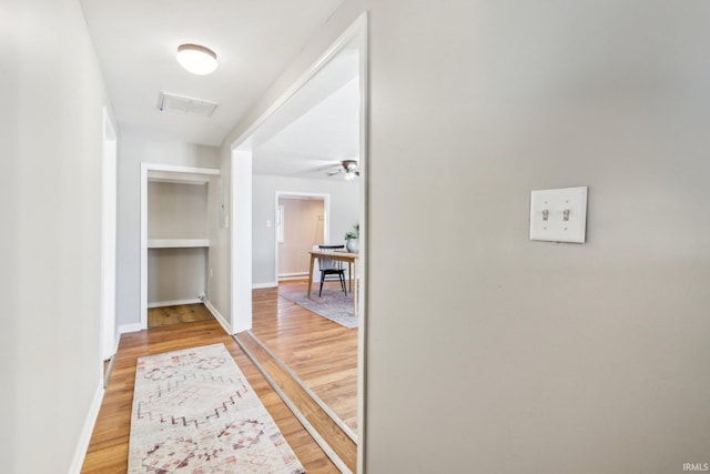 hallway with hardwood / wood-style floors