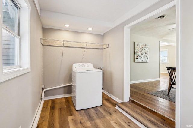 washroom featuring washer / clothes dryer, plenty of natural light, and hardwood / wood-style flooring