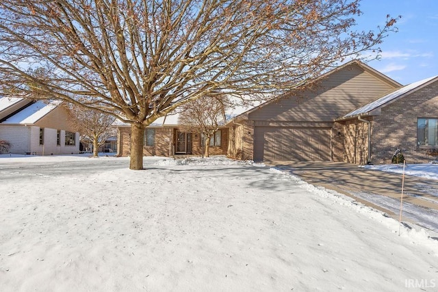 snowy yard with a garage