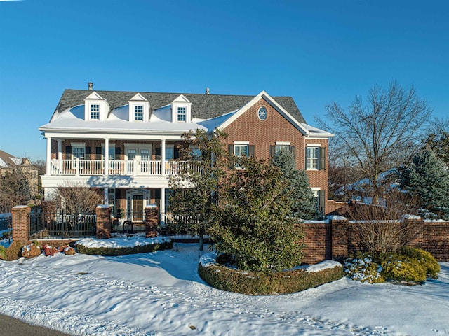 view of front facade with covered porch and a balcony