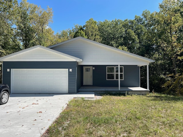 ranch-style house with covered porch, a front yard, and a garage