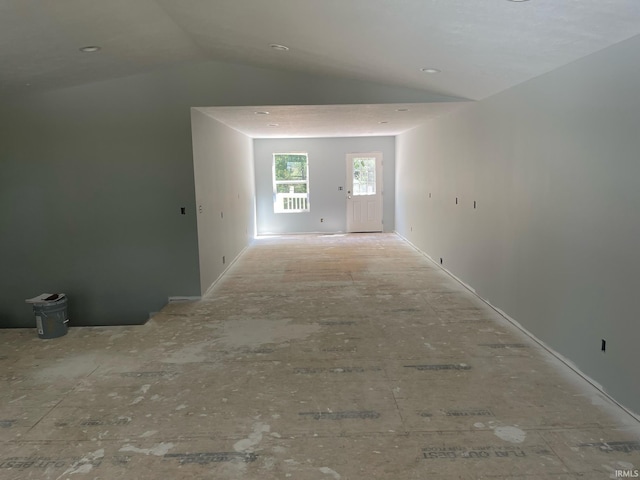 hall featuring lofted ceiling