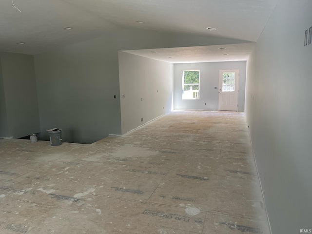 empty room featuring lofted ceiling