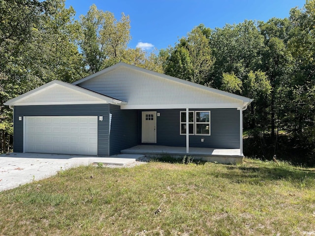 view of front of home with a front yard, covered porch, and a garage