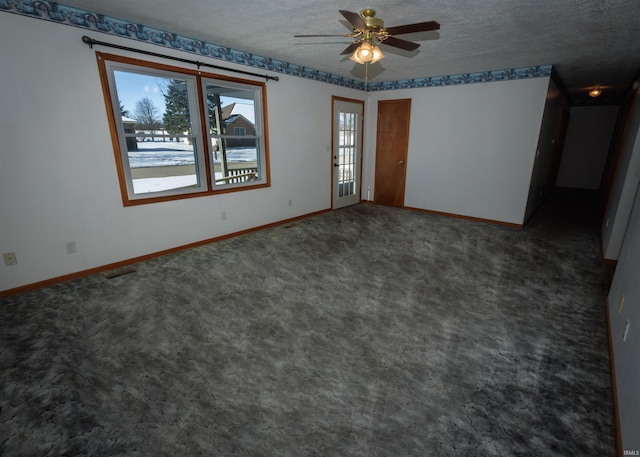 unfurnished room featuring ceiling fan, a textured ceiling, and dark colored carpet