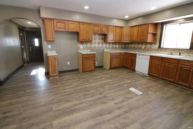 kitchen with tasteful backsplash, sink, dark hardwood / wood-style floors, and dishwasher