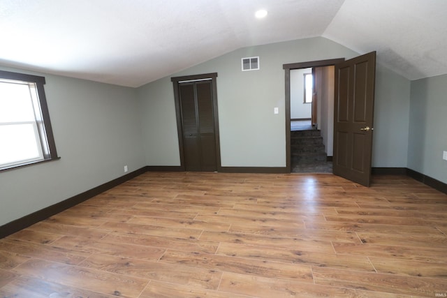 interior space featuring vaulted ceiling and light hardwood / wood-style floors