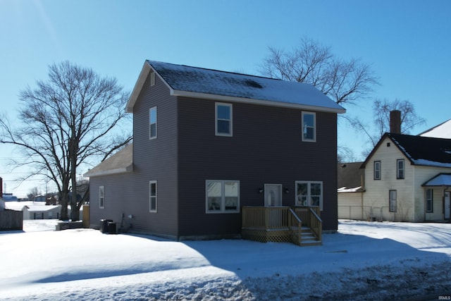 snow covered house with cooling unit