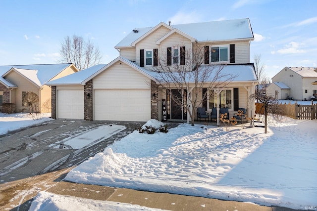 view of property with covered porch and a garage