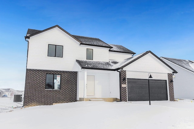 view of front of property with a garage and central air condition unit