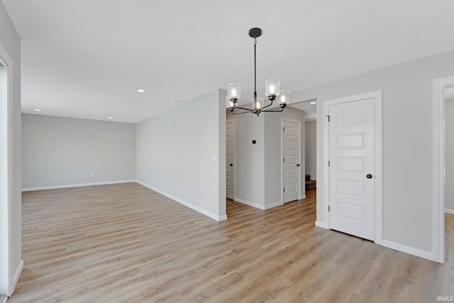 interior space featuring light wood-type flooring and an inviting chandelier