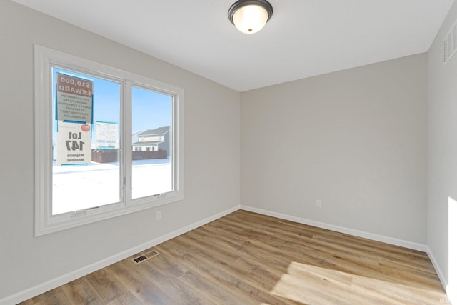 unfurnished room with light hardwood / wood-style flooring