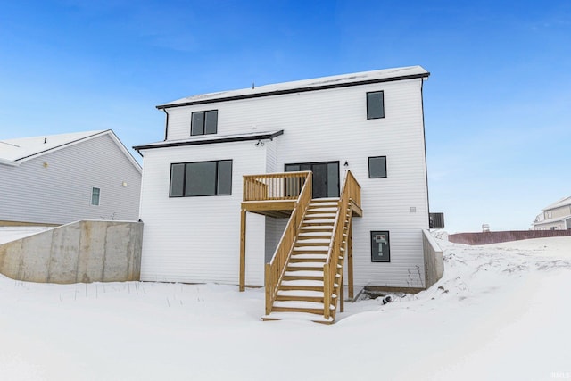 snow covered property with a deck