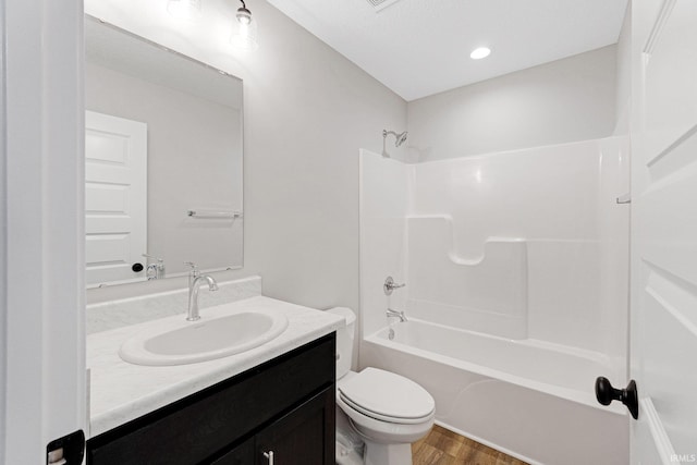 full bathroom with toilet, shower / bath combination, vanity, and hardwood / wood-style floors