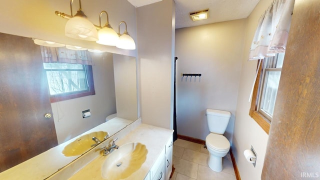 bathroom with toilet, tile patterned flooring, and vanity