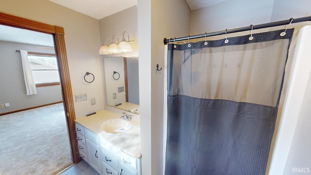 bathroom with curtained shower and vanity