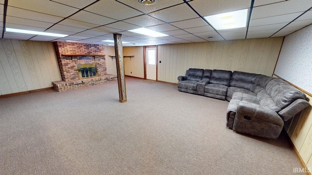 living room with a fireplace, light colored carpet, and a paneled ceiling