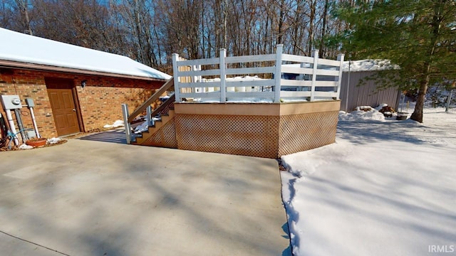 snowy yard featuring a wooden deck