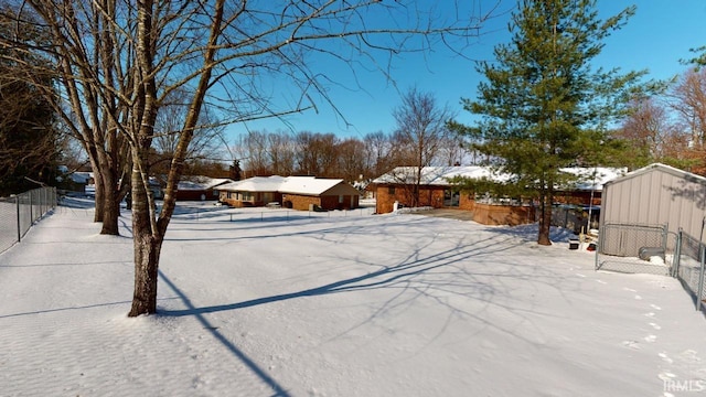 view of yard layered in snow