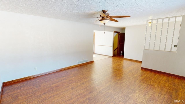 unfurnished room with wood-type flooring, a textured ceiling, and ceiling fan