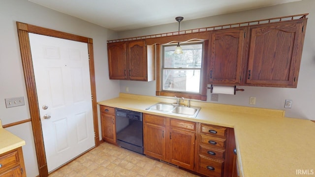 kitchen featuring pendant lighting, black dishwasher, and sink