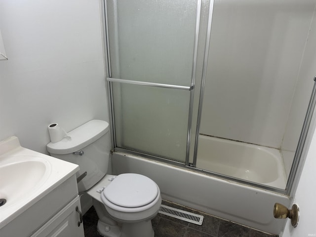 full bathroom with toilet, vanity, and bath / shower combo with glass door