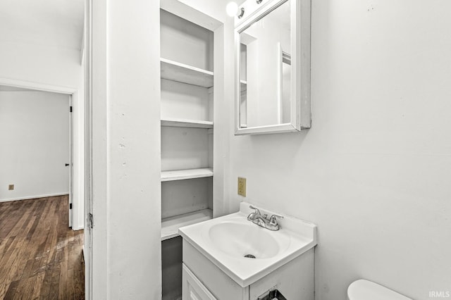 bathroom with vanity, hardwood / wood-style floors, and toilet