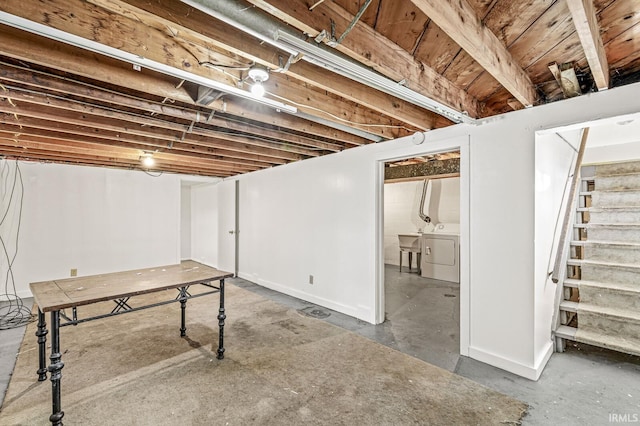 basement featuring separate washer and dryer and sink