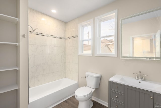 full bathroom featuring toilet, vanity, hardwood / wood-style flooring, and tiled shower / bath