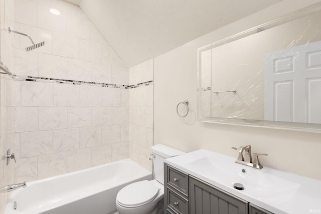 full bathroom with tiled shower / bath combo, toilet, vanity, a textured ceiling, and lofted ceiling