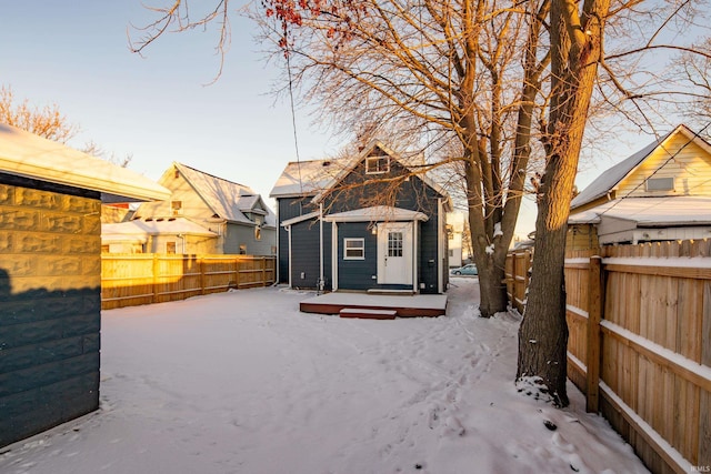 yard layered in snow featuring an outbuilding