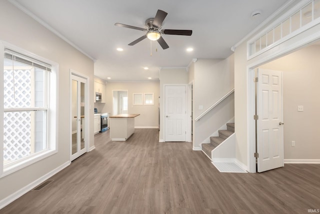 unfurnished living room with a healthy amount of sunlight and dark hardwood / wood-style flooring