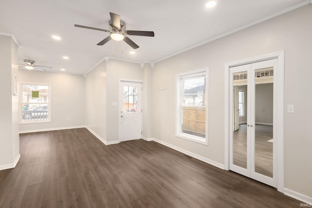 spare room with ceiling fan, dark wood-type flooring, french doors, and ornamental molding