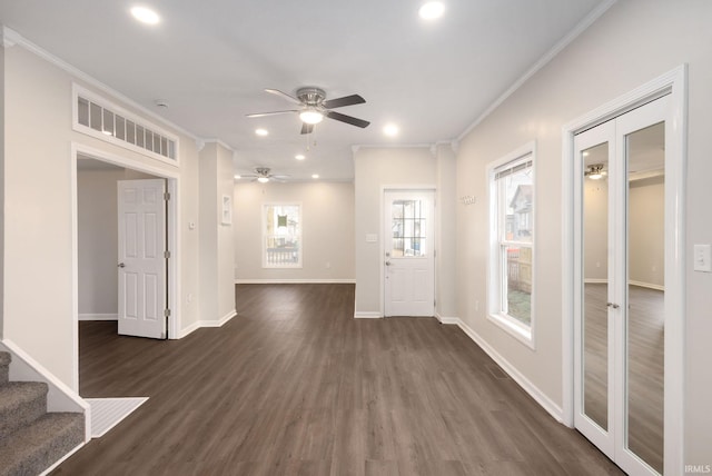 foyer entrance with french doors, dark hardwood / wood-style flooring, ornamental molding, and ceiling fan