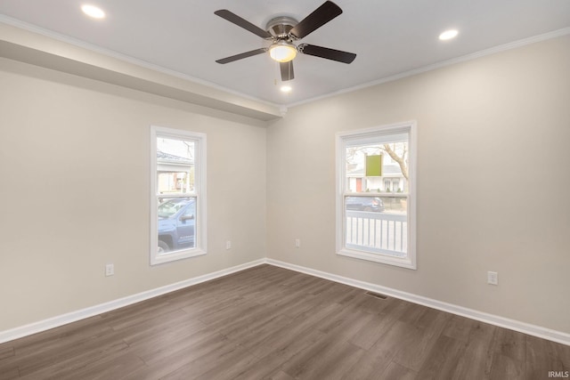 empty room featuring ceiling fan, crown molding, and dark hardwood / wood-style floors