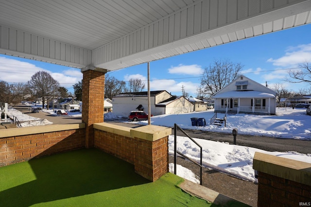 snow covered patio with covered porch