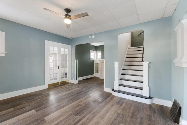 foyer entrance with ceiling fan, a paneled ceiling, french doors, and dark hardwood / wood-style floors