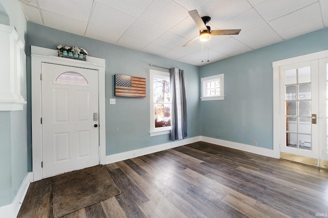 entryway with ceiling fan, dark wood-type flooring, and a paneled ceiling