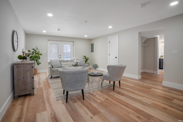 living room with light wood-type flooring and french doors