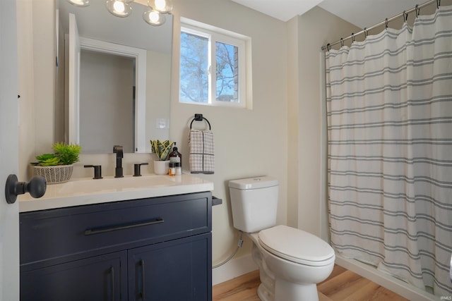 bathroom with toilet, hardwood / wood-style flooring, a shower with shower curtain, and vanity