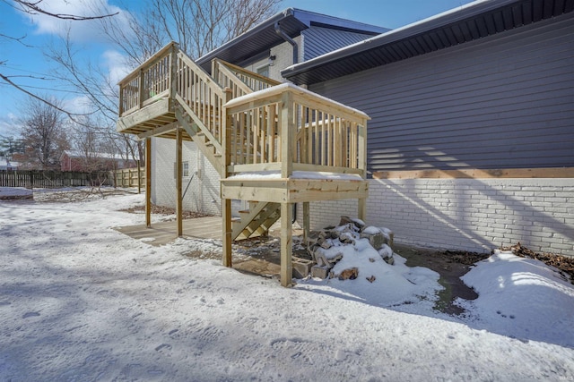 snow covered property featuring a wooden deck