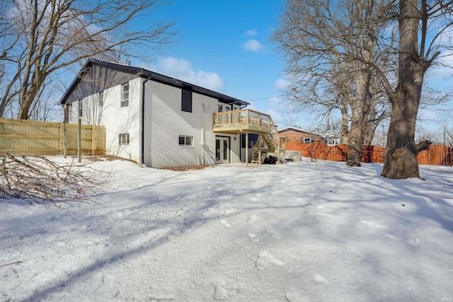 snow covered property featuring a wooden deck