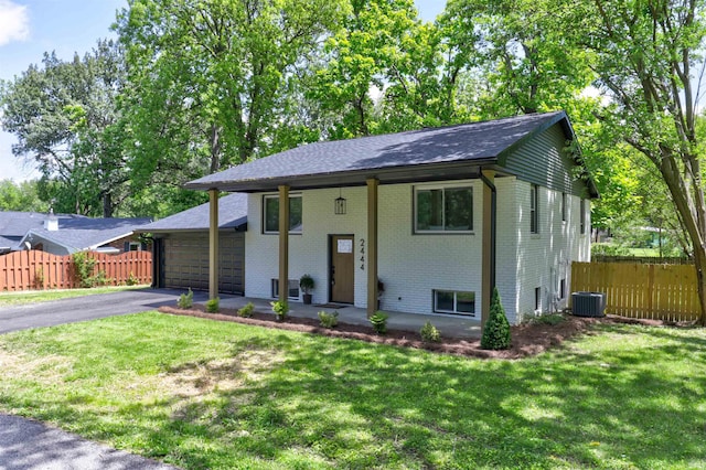 2444 Clover Cir, Newburgh, IN 47630 - raised ranch with brick siding, an attached garage, driveway, central air condition unit, and a porch