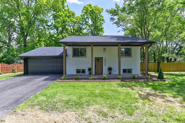 2444 Clover Cir, Newburgh, IN 47630 - raised ranch with brick siding, driveway, a garage, and a shingled roof